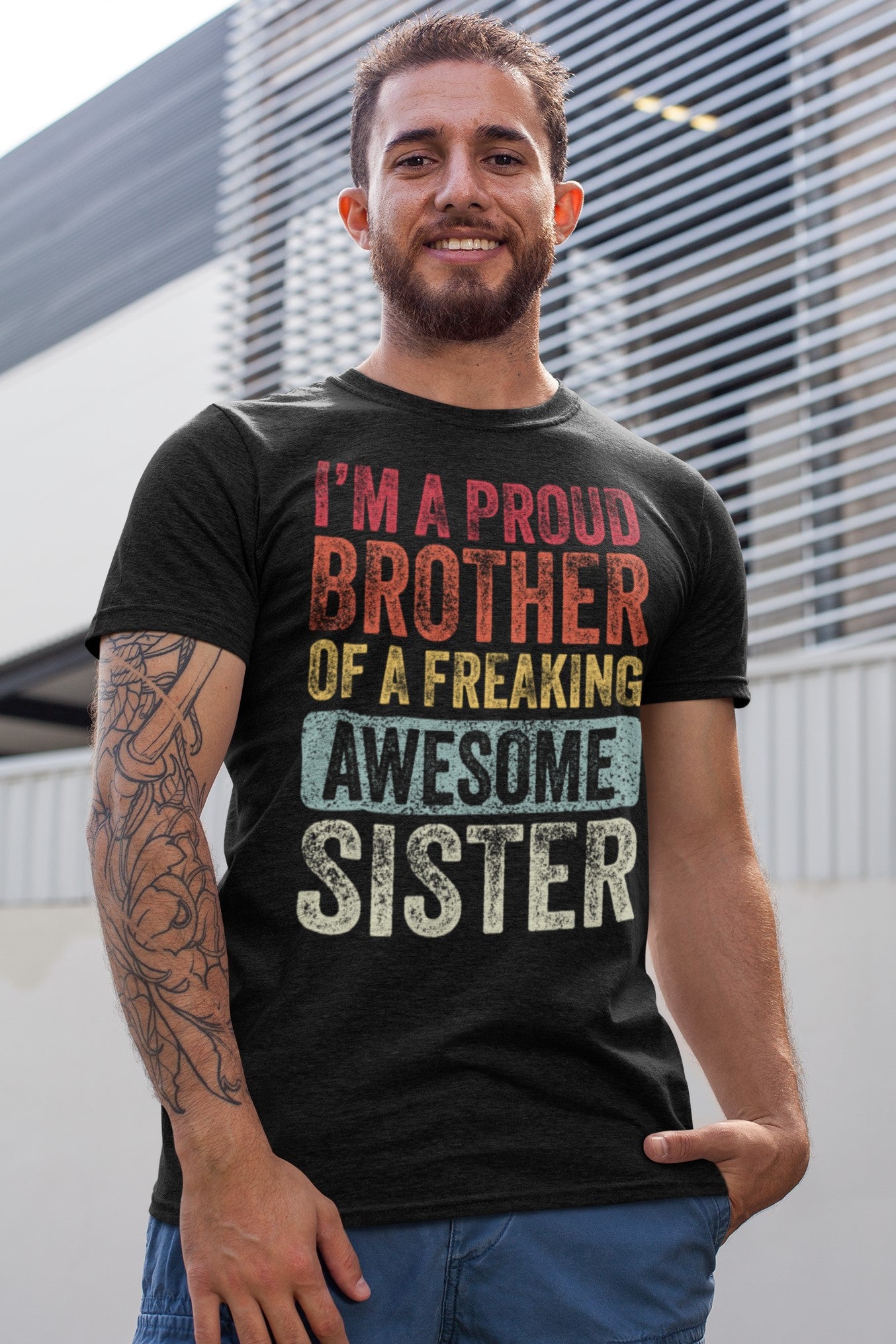 Vintage Funny I’m a Proud Brother of a Freaking Awesome Sister Retro T-shirt, heathered-t-shirt-mockup-of-a-tattooed-man-smiling