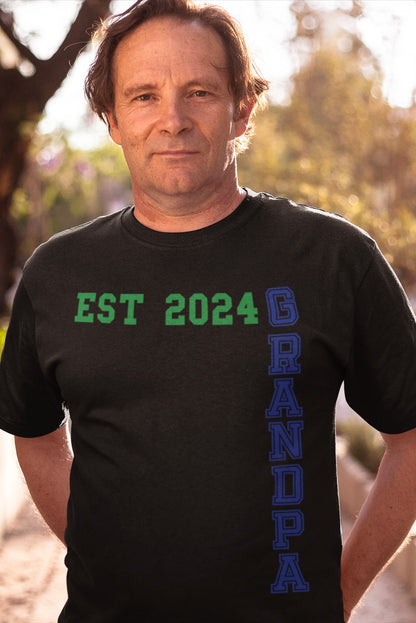 Funny Grandpa Est 2024 Cool T-shirt,  middle-aged-man-grandfather-wearing-a-round-neck-printondemand-family-tshirt-mockup-while-standing-against-the-sun